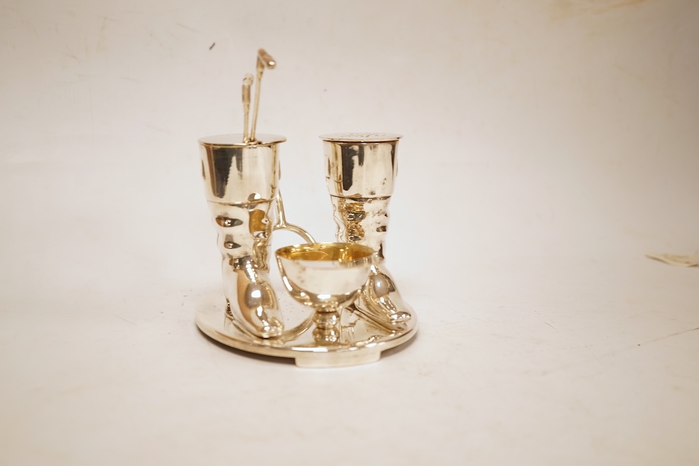 A novelty horse-related cruet stand, a pair of silver mounted horn beakers and three other items